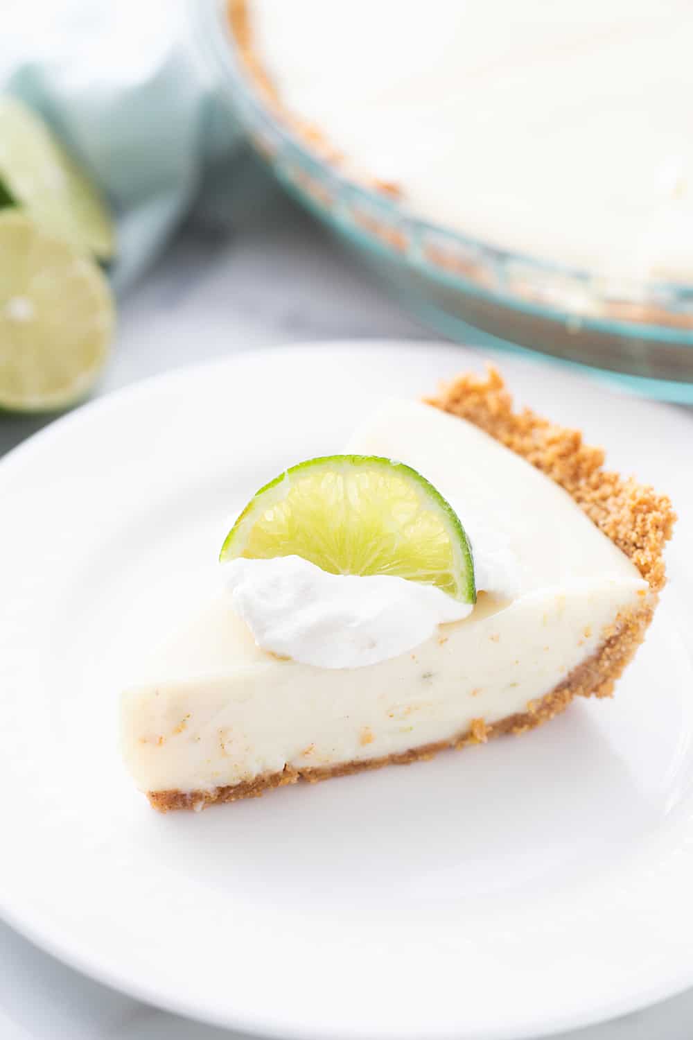 Easy Key Lime Pie with Homemade Whipped Cream - This easy key lime pie calls for a homemade graham cracker crust and the easiest pie filling ever. Top it with homemade whipped cream and it's always a hit! #keylime #keylimepie #whippedcream #dessert #baking #pie #lime #halfscratched