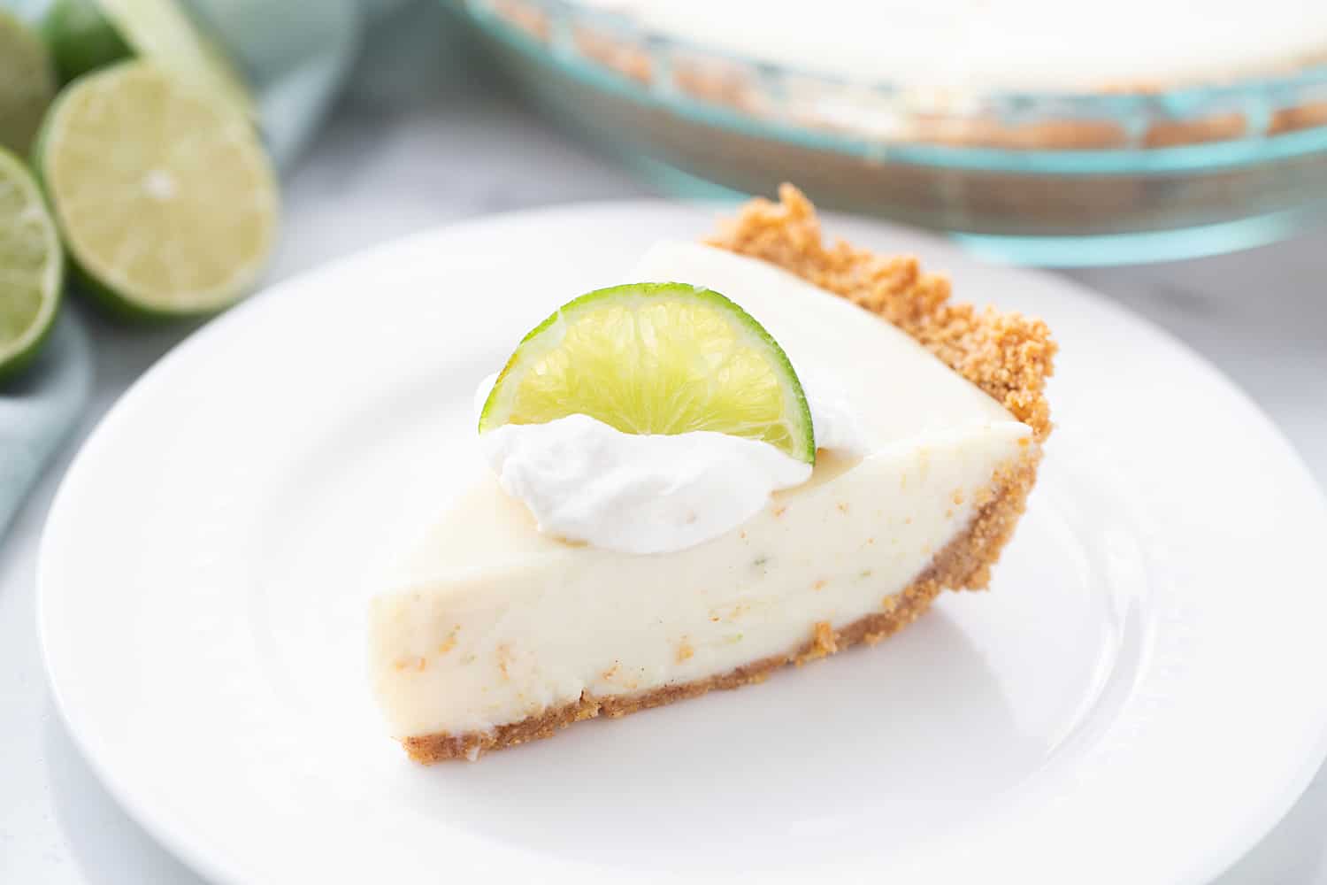 Easy Key Lime Pie with Homemade Whipped Cream - This easy key lime pie calls for a homemade graham cracker crust and the easiest pie filling ever. Top it with homemade whipped cream and it's always a hit! #keylime #keylimepie #whippedcream #dessert #baking #pie #lime #halfscratched