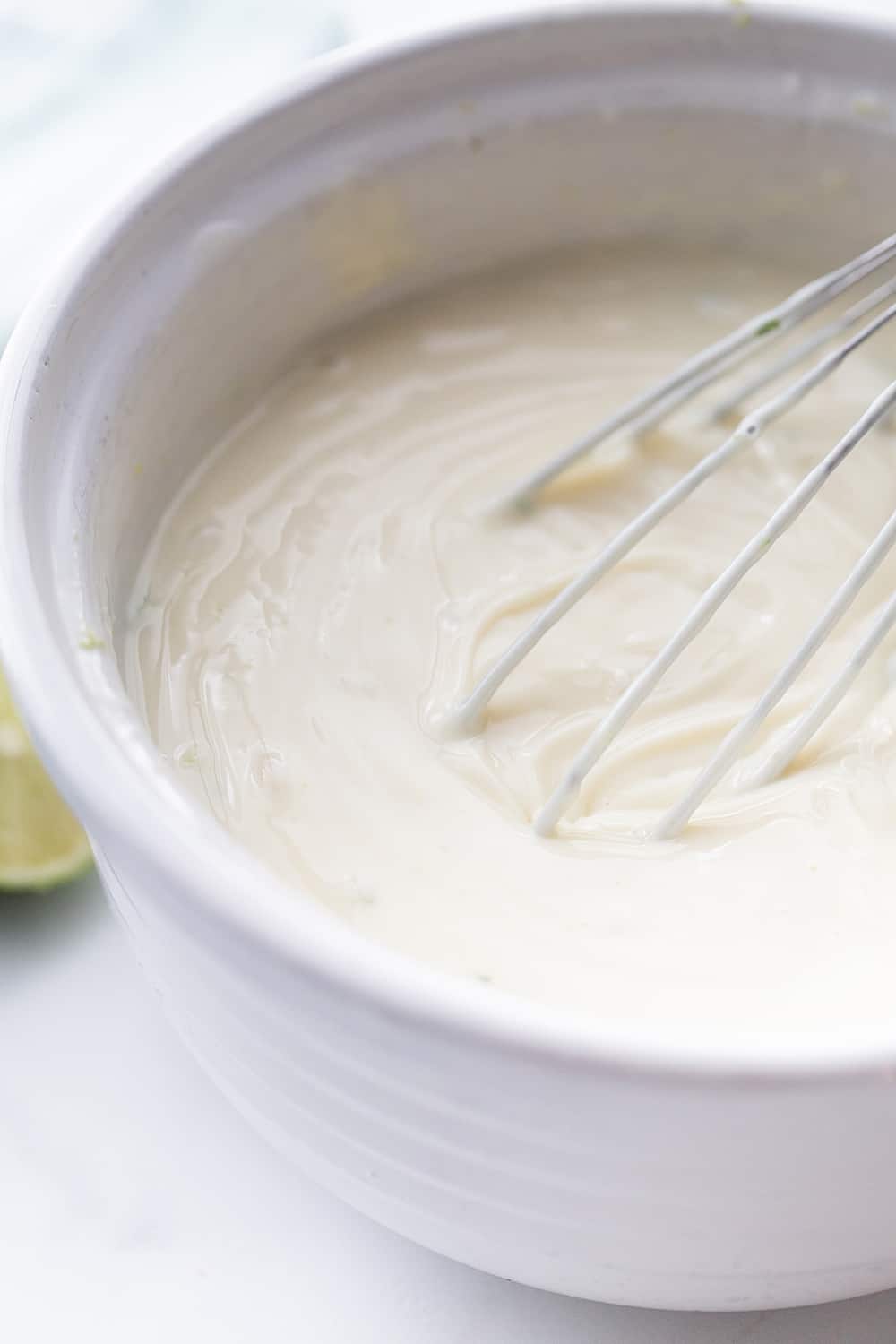 Easy Key Lime Pie with Homemade Whipped Cream - This easy key lime pie calls for a homemade graham cracker crust and the easiest pie filling ever. Top it with homemade whipped cream and it's always a hit! #keylime #keylimepie #whippedcream #dessert #baking #pie #lime #halfscratched