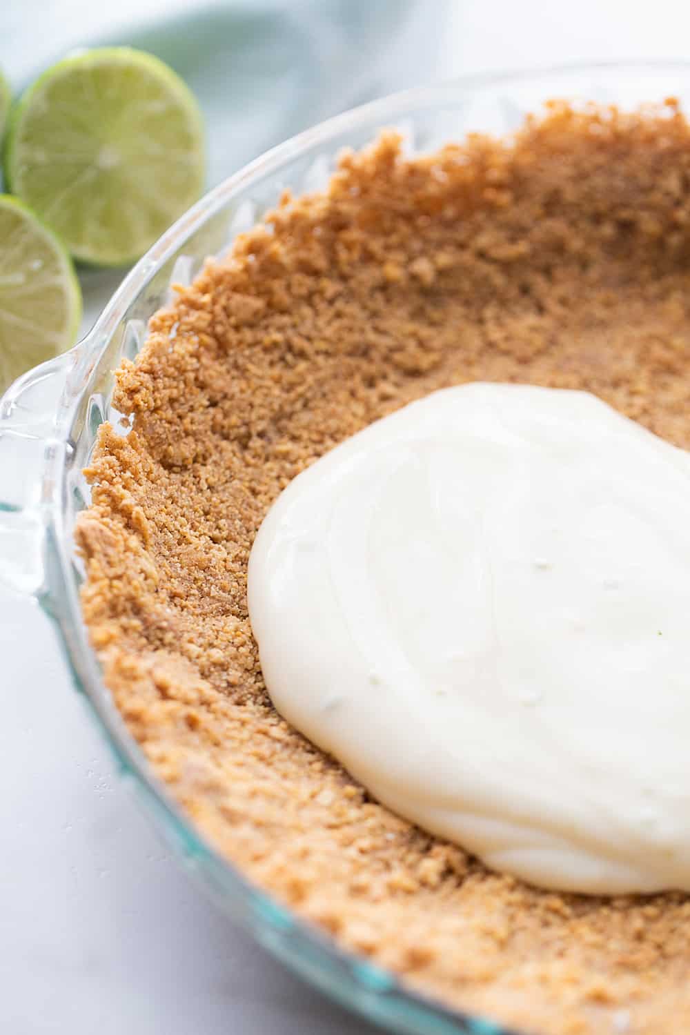 Easy Key Lime Pie with Homemade Whipped Cream - This easy key lime pie calls for a homemade graham cracker crust and the easiest pie filling ever. Top it with homemade whipped cream and it's always a hit! #keylime #keylimepie #whippedcream #dessert #baking #pie #lime #halfscratched