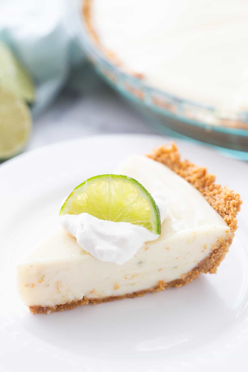 Easy Key Lime Pie with Homemade Whipped Cream - This easy key lime pie calls for a homemade graham cracker crust and the easiest pie filling ever. Top it with homemade whipped cream and it's always a hit! #keylime #keylimepie #whippedcream #dessert #baking #pie #lime #halfscratched