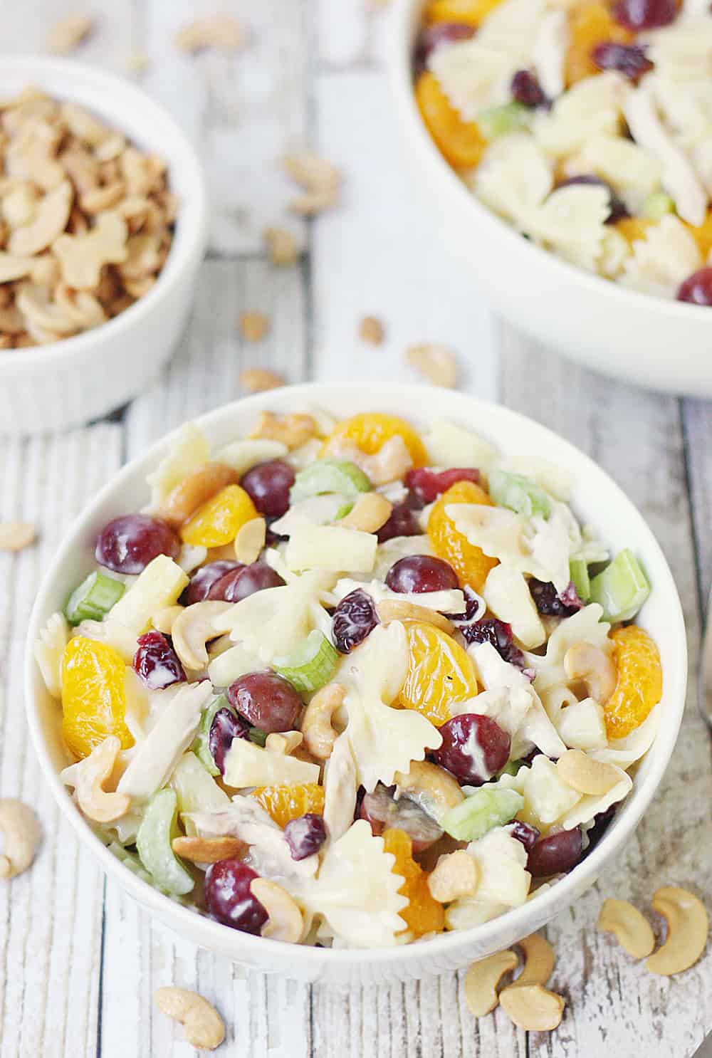 Chicken Bow Tie Pasta Salad -- Chicken bow tie pasta salad is the perfect summer salad! It combines so many delicious ingredients with the crunch of cashews and creamy coleslaw dressing.
