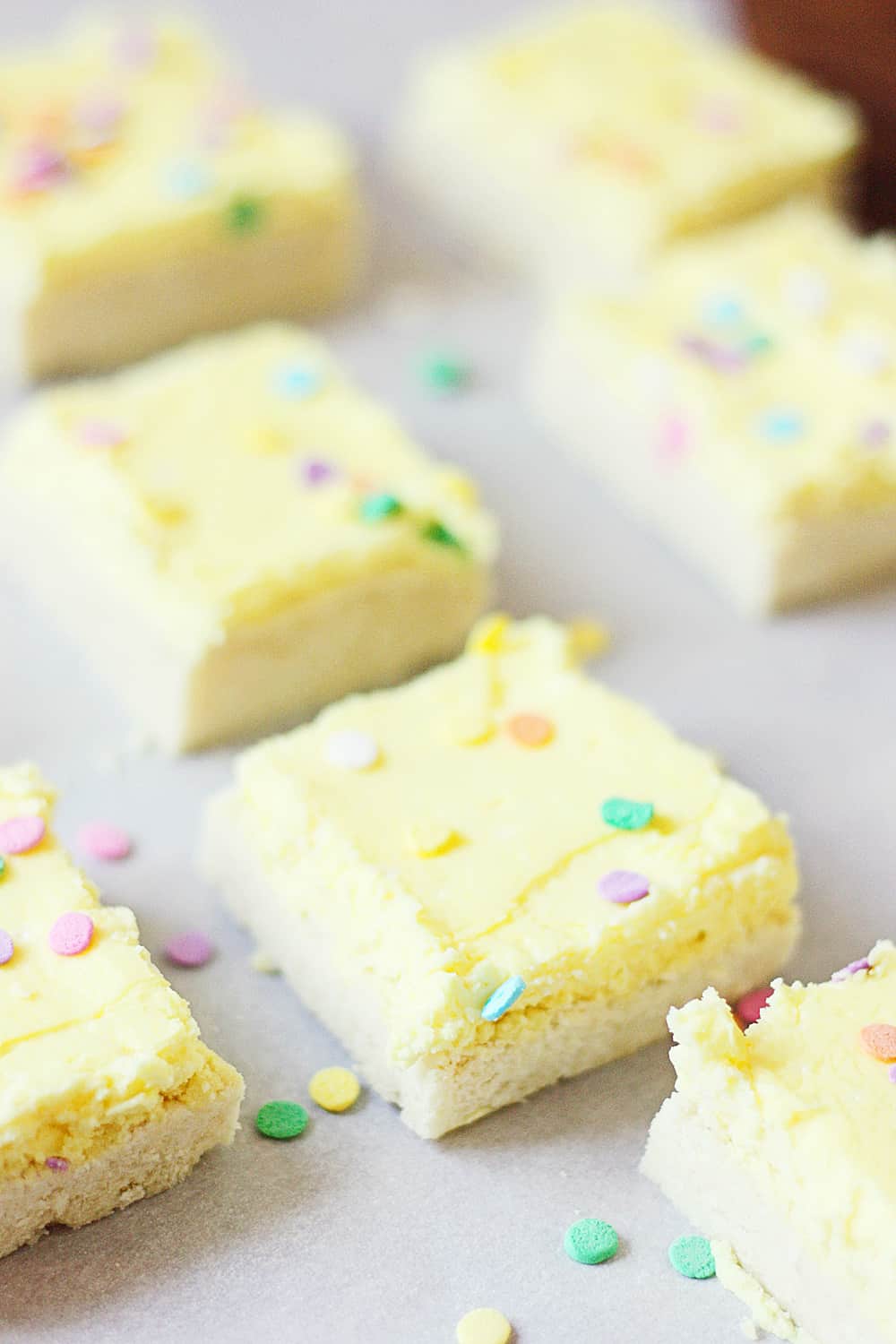 Sugar Cookie Bars - Sugar cookie bars are great for serving a crowd. They're soft and chewy and the frosting is to die for! Plus, they're quicker to make than their individually-portioned sugar cookie counterparts. | halfscratched.com