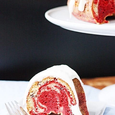 Chocolate Chip Red Velvet Swirl Bundt Cake -- Chocolate chip red velvet swirl bundt cake combined two flavors of cake mix with mini chocolate chips for a delicious Valentine's Day dessert! | halfscratched.com #cake #recipe #dessert #redvelvet