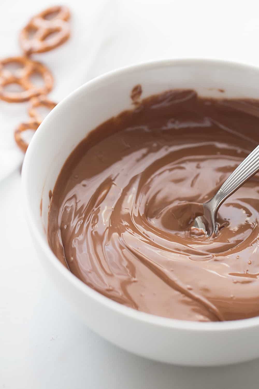 Cookie Dough Pretzel Bites mixing chocolate.