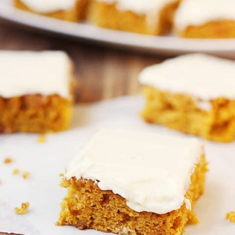 Pumpkin Bars with Orange Butter Frosting -- These pumpkin bars with orange butter frosting are so dang good you'll want to eat them year round. And you totally should.