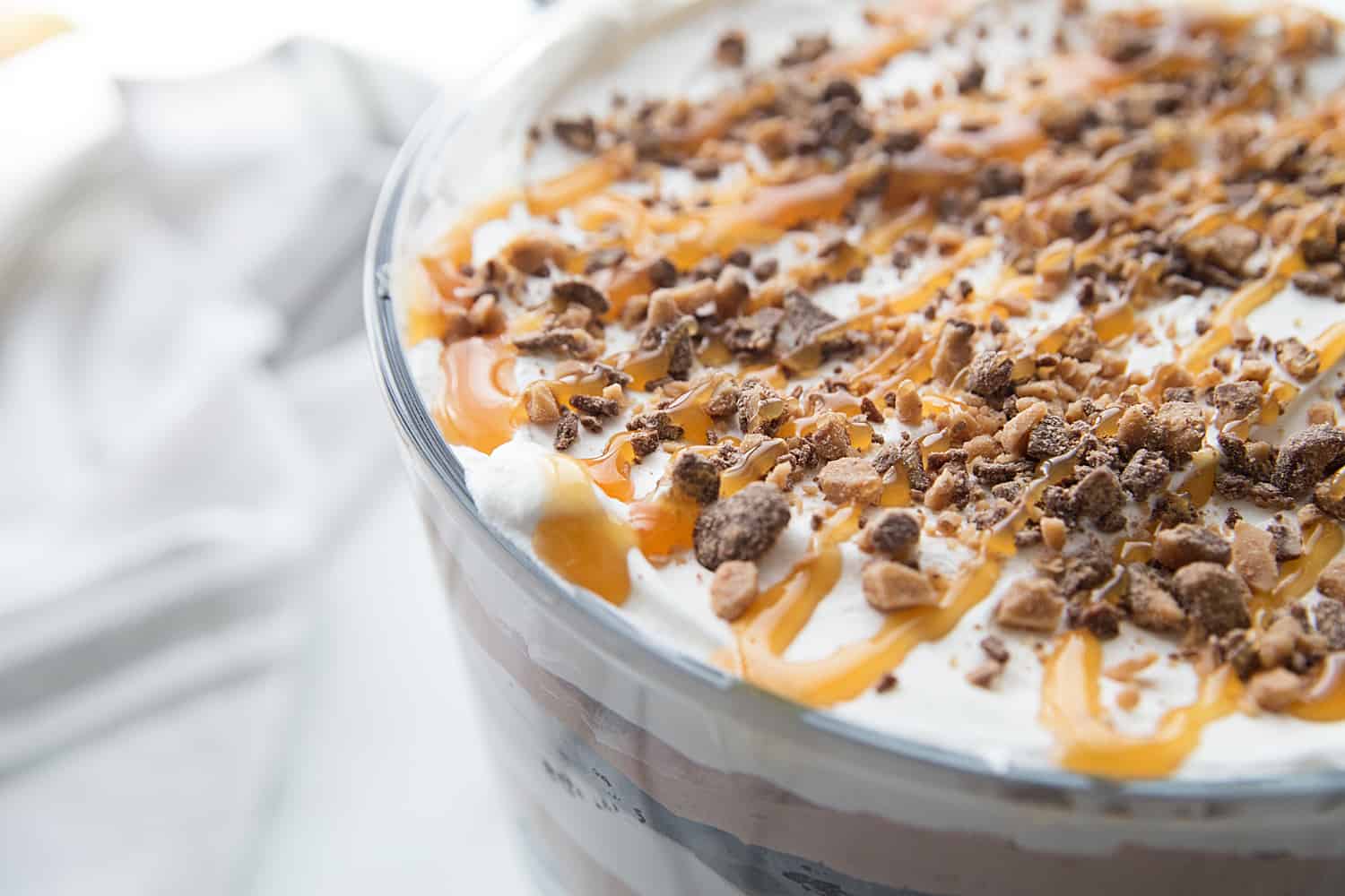 Chocolate Brownie Trifle - Chocolate brownie trifle features layers of rich, chocolate brownies, fudge pudding, whipped topping, toffee, and caramel. What's not to love? #trifle #brownie #dessert #halfscratched #chocolatetrifle #brownietrifle #sweet #baking