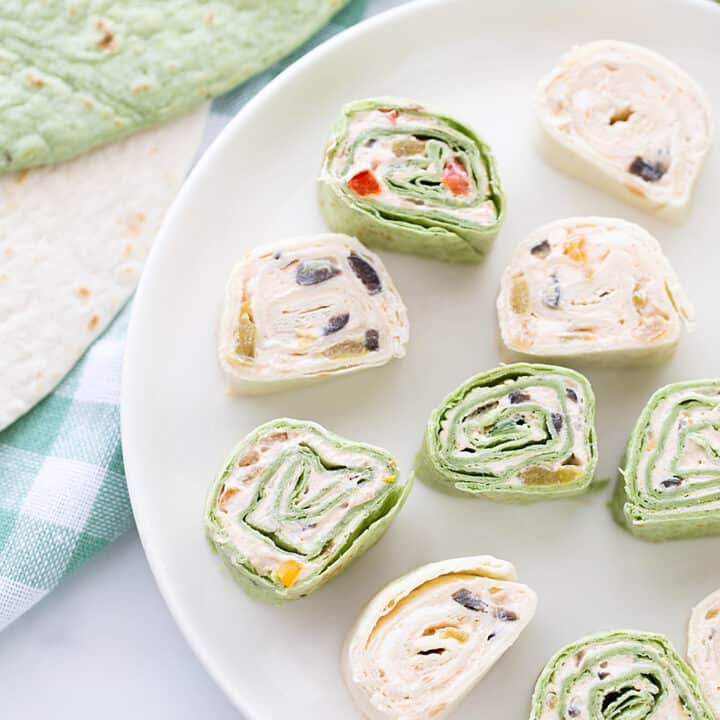 Mexican Pinwheels - Mexican pinwheels are the best appetizer! They're so eays and so flavorful. And even better, you can make them a day ahead! #appetizer #halfscratched #pinwheels #appetizerrecipe #partyfood #easyrecipe #easyappetizer #creamcheese