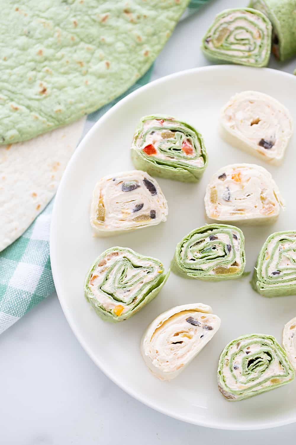 Mexican Pinwheels - Mexican pinwheels are the best appetizer! They're so eays and so flavorful. And even better, you can make them a day ahead! #appetizer #halfscratched #pinwheels #appetizerrecipe #partyfood #easyrecipe #easyappetizer #creamcheese