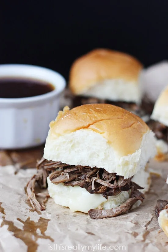 French Dip Sliders - so easy to make using a slow cooker and Hawaiian rolls. So fun to eat thanks to the smaller size!