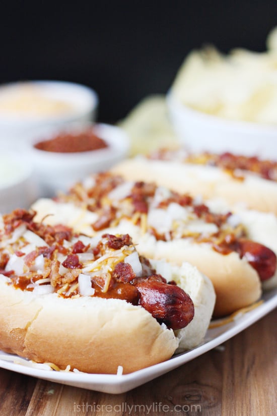 Double Bacon Chili Cheese Dog - hot dogs wrapped with bacon, grilled and topped with chili, cheese, onion and more bacon! Recipe from halfscratched.com