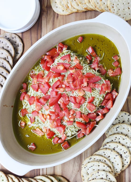 This layered pesto dip has only four ingredients and is ready in 15 minutes! Pair with your favorite crackers for the perfect hot dip! #halfscratched #appetizer #hotappetizer #easyrecipe #holidayrecipe #baking #cooking #easyappetizer #pesto #pestodip #bretoncrackers #clevergirls #ad