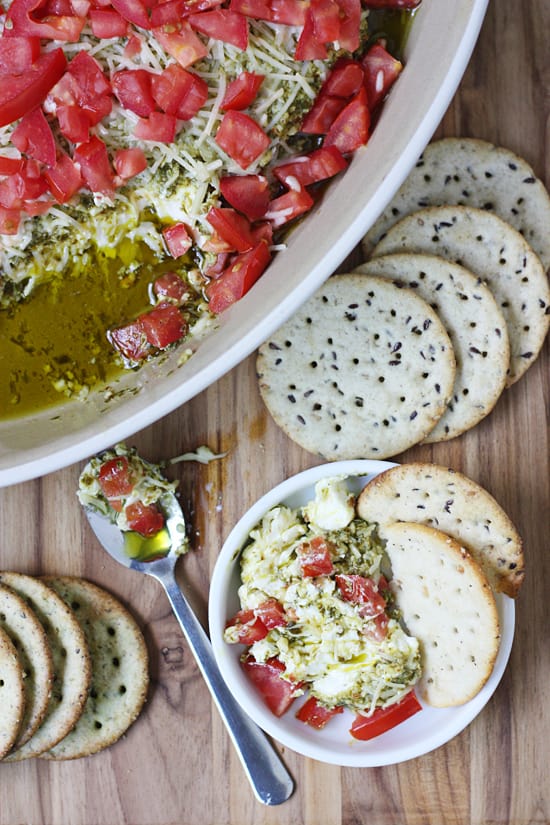 This layered pesto dip has only four ingredients and is ready in 15 minutes! Pair with your favorite crackers for the perfect hot dip! #halfscratched #appetizer #hotappetizer #easyrecipe #holidayrecipe #baking #cooking #easyappetizer #pesto #pestodip #bretoncrackers #clevergirls #ad