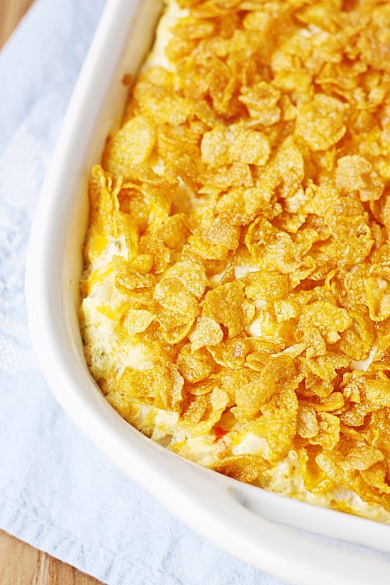 BEST Cheesy Potatoes with O'Brien Potatoes in a oven pan close-up.