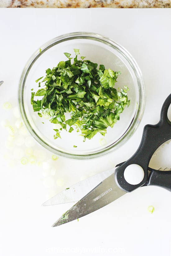 Chopping herbs with kitchen shears