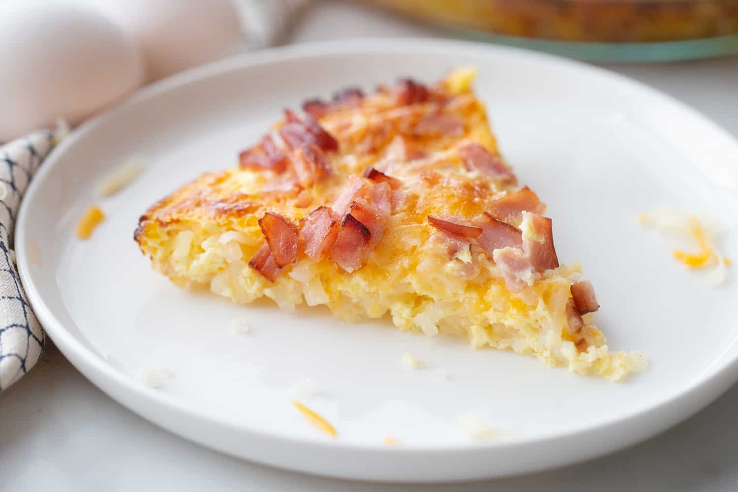 Hashbrown Breakfast Casserole slice on a plate side view.