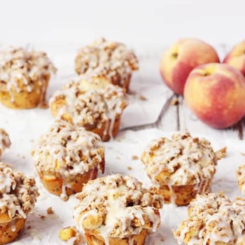 Peach Crisp Monkey Bread Muffins -- These peach crisp monkey bread muffins combine fresh, diced peaches, a delicious crumble topping and cinnamon roll dough for an easy, scrumptious treat! | halfscratched.com