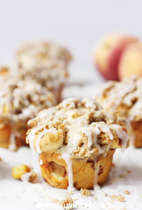 Peach Crisp Monkey Bread Muffins -- These peach crisp monkey bread muffins combine fresh, diced peaches, a delicious crumble topping and cinnamon roll dough for an easy, scrumptious treat! | halfscratched.com