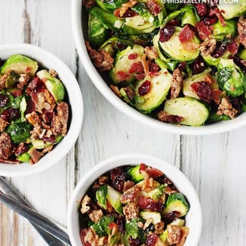 Sauteed Brussels Sprouts with Bacon -- Sauteed brussels sprouts turn into the most scrumptious side dish after being tossed with crumbled bacon, craisins and candied pecans. | halfscratched.com
