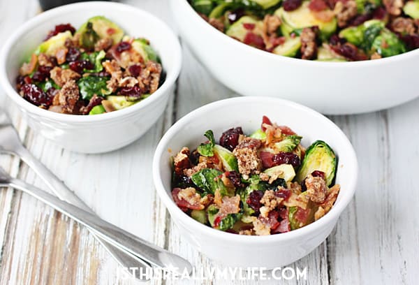Sauteed Brussels Sprouts with Bacon -- Sauteed brussels sprouts turn into the most scrumptious side dish after being tossed with crumbled bacon, craisins and candied pecans. | halfscratched.com