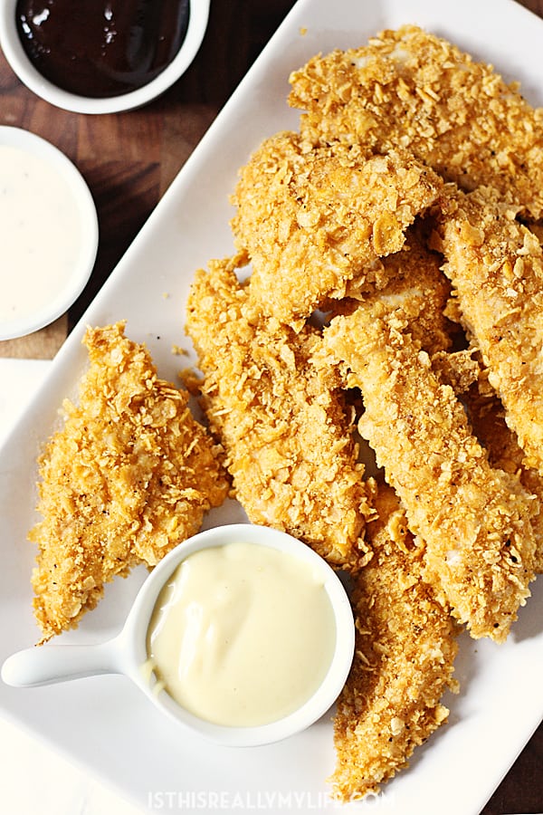 Baked Chicken Fingers - Corn flakes and spices are the secret to these healthy baked chicken fingers with homemade honey mustard. This recipe is totally kid tested and approved! | halfscratched.com