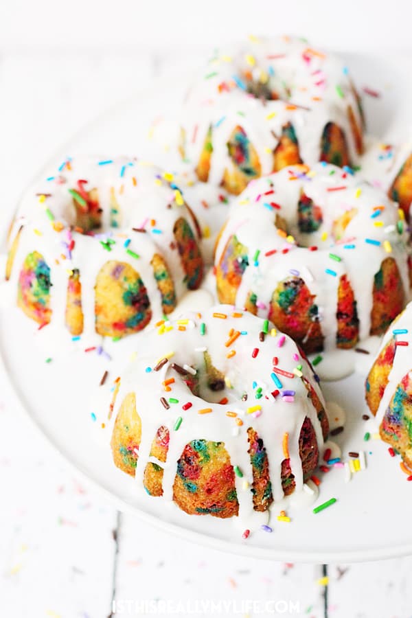 Mini Funfetti Bundt Cake with Vanilla Glaze -- Mini funfetti bundt cakes with vanilla glaze are a fun party dessert. Perfect topped with a scoop of ice cream, whipped cream, more sprinkles and a cherry! | halfscratched.com