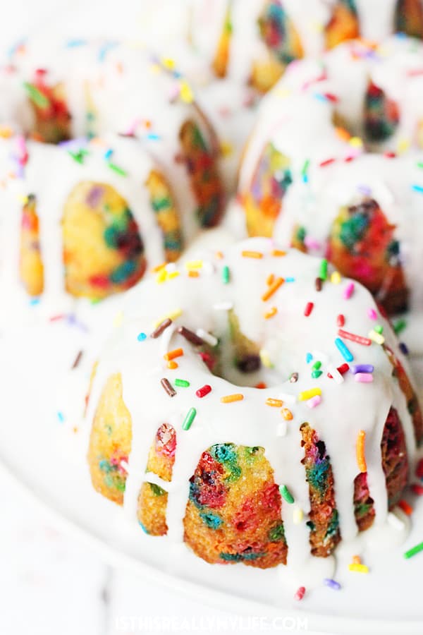 Mini Funfetti Bundt Cake with Vanilla Glaze -- Mini funfetti bundt cakes with vanilla glaze are a fun party dessert. Perfect topped with a scoop of ice cream, whipped cream, more sprinkles and a cherry! | halfscratched.com