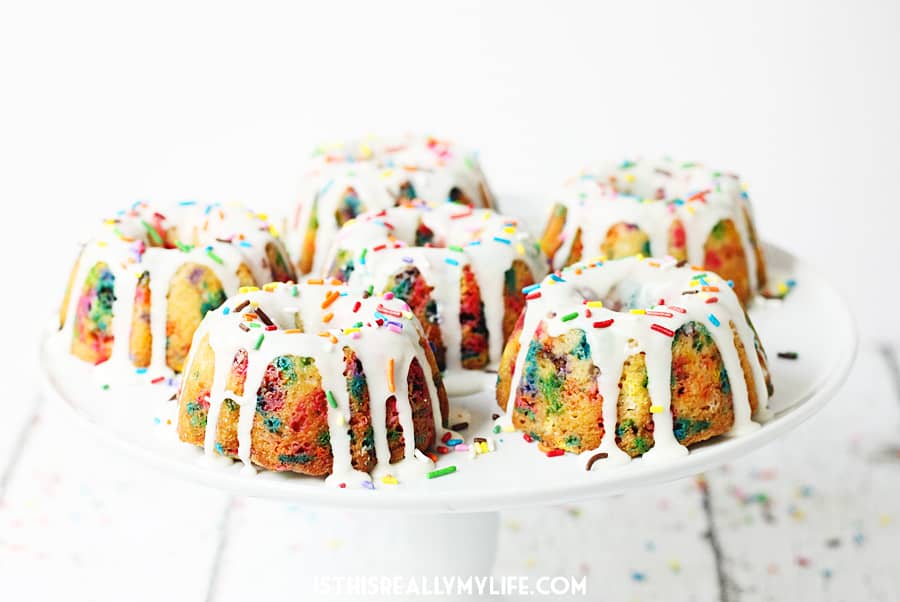 Mini Funfetti Bundt Cake with Vanilla Glaze -- Mini funfetti bundt cakes with vanilla glaze are a fun party dessert. Perfect topped with a scoop of ice cream, whipped cream, more sprinkles and a cherry! | halfscratched.com