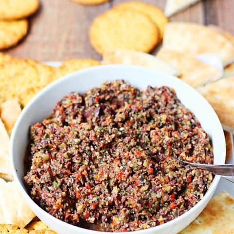 Triple Olive Tapenade -- This triple olive tapenade features Kalamata, green & California olives. Freshly roasted red bell pepper, garlic & Italian herbs makes it extra addictive! | halfscratched.com