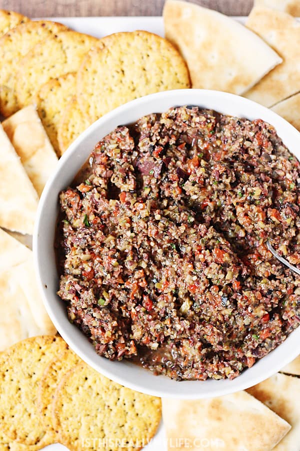 Triple Olive Tapenade -- This triple olive tapenade features Kalamata, green & California olives. Freshly roasted red bell pepper, garlic & Italian herbs makes it extra addictive! | halfscratched.com
