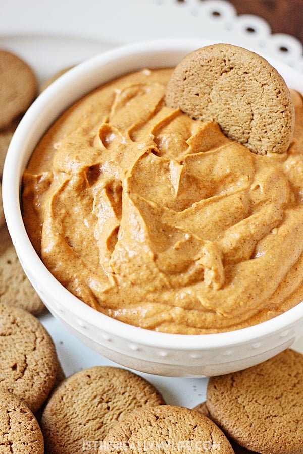 Easy Fluffy Pumpkin Dip -- This pumpkin dip is full of pumpkin spice flavor and super easy to make. It is so creamy, fluffy and yummy you'll want to serve it at every holiday party! | halfscratched.com #pumpkin #recipe