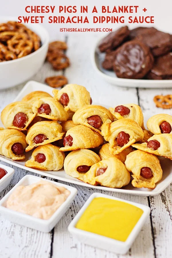 Cheesy Pigs in a Blanket + Sweet Sriracha Dipping Sauce -- After tasting these cheesy pigs in a blanket with sweet sriracha dipping sauce, you'll want to serve them at every game day party! | halfscratched.com
