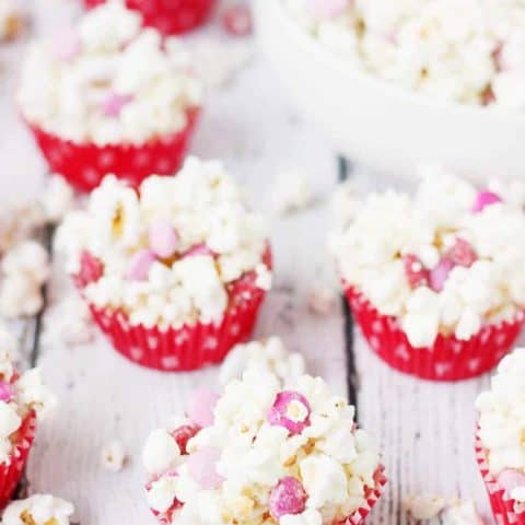 3-Ingredient Valentine's Popcorn Balls -- Valentine's popcorn balls are a super fun treat to serve at your Valentine's parties. With only three ingredients, they're super quick and easy to make! | halfscratched.com #valentinesday #recipe #popcorn