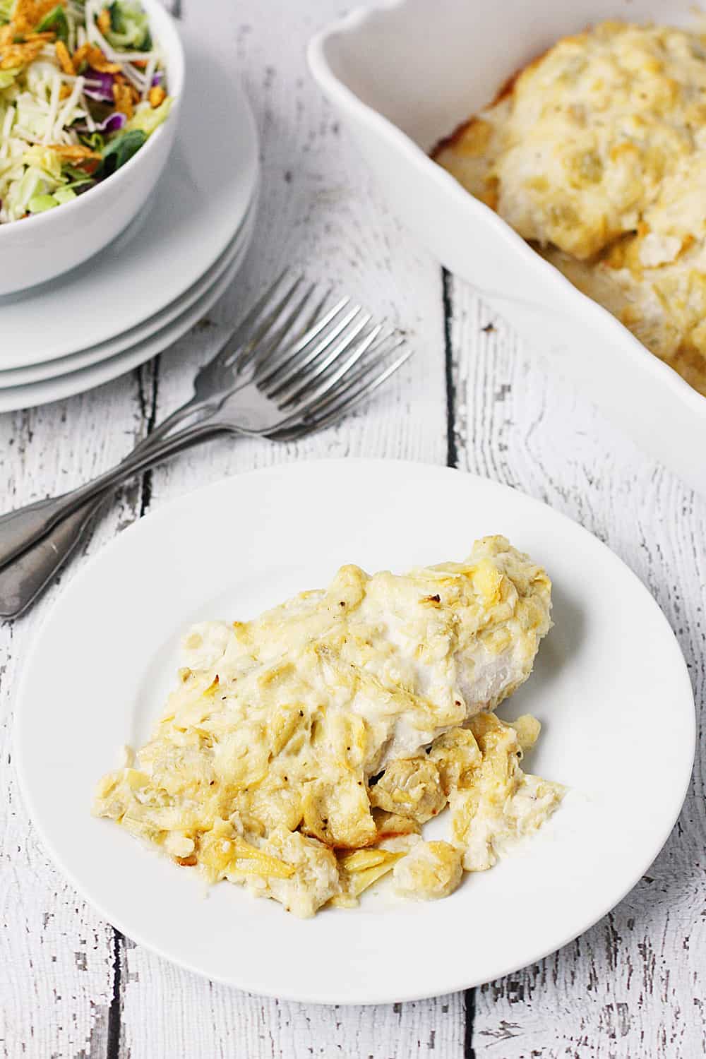 Artichoke Chicken Bake - This artichoke chicken bake has only five ingredients, including the chicken breasts, and tastes like baked chicken smothered with hot artichoke dip.