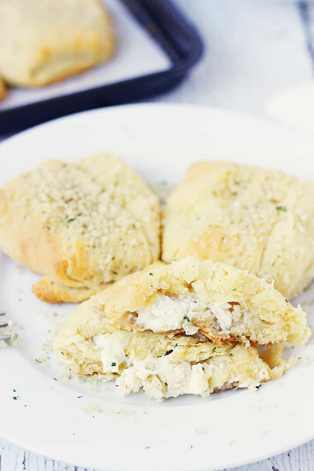 Creamy Chicken Crescent Rolls -- Creamy chicken crescent rolls are a family favorite. Flaky crescent roll dough is filled with a creamy chicken mixture and topped with melted butter and seasoned bread crumbs. Plus you can freeze the leftovers! | halfscratched.com #recipes #easyrecipe #chicken