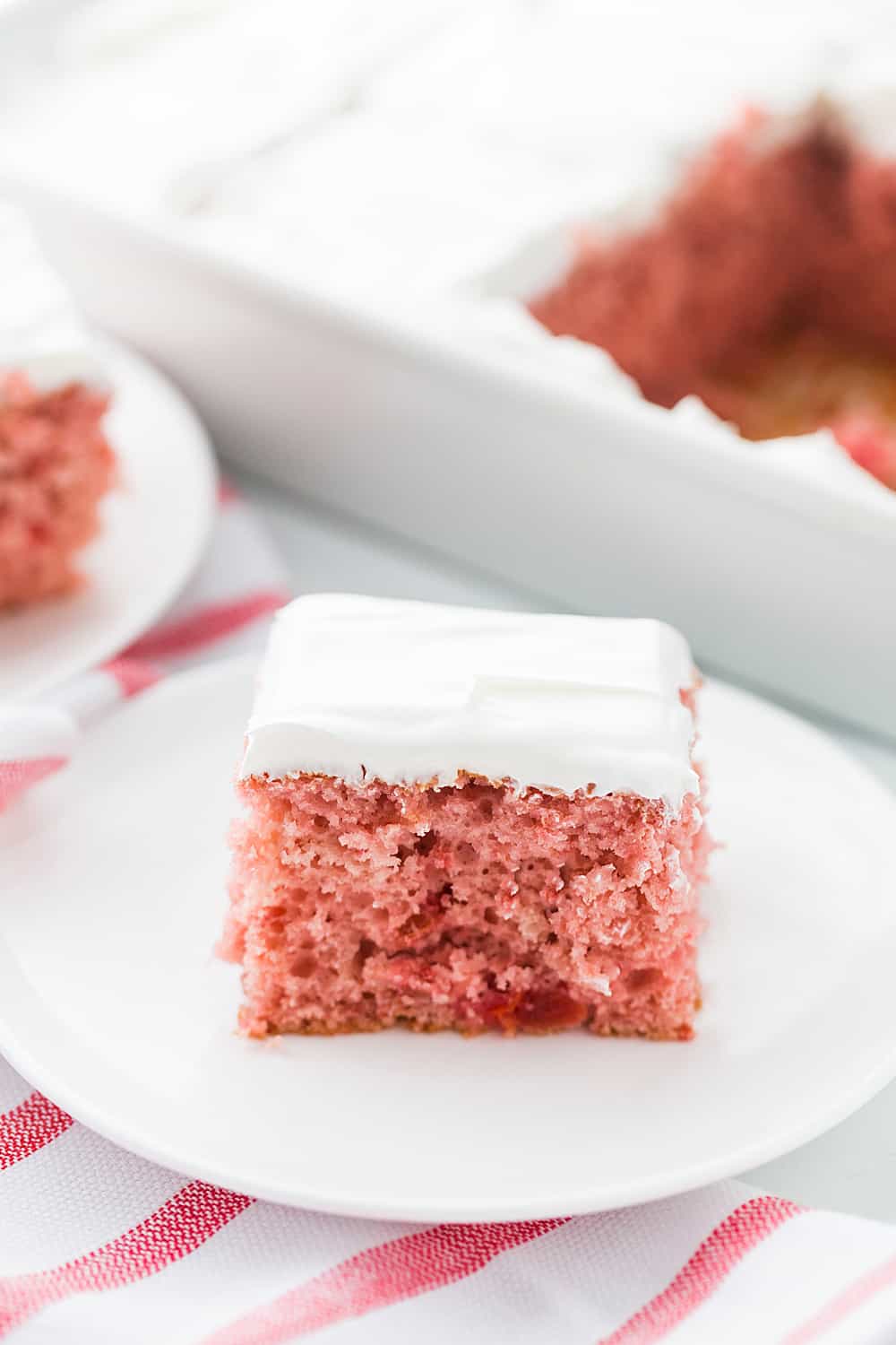 Easy Cherry Cake - Easy cherry cake with whipped topping is unbelievably delicious and requires only a white cake mix, cherry pie filling, and a few other ingredients. Whipped topping frosting is the finishing touch! #cherry #cherrycake #cakemix #cake #baking #sweets #dessert #halfscratched