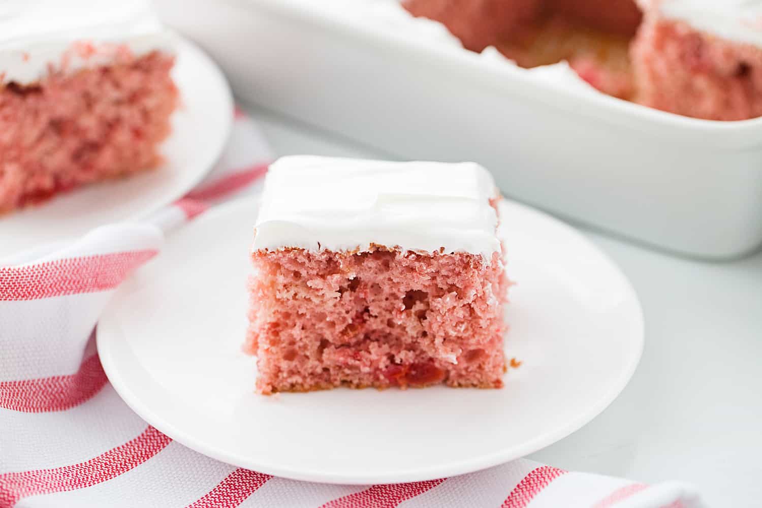 Easy Cherry Cake - Easy cherry cake with whipped topping is unbelievably delicious and requires only a white cake mix, cherry pie filling, and a few other ingredients. Whipped topping frosting is the finishing touch! #cherry #cherrycake #cakemix #cake #baking #sweets #dessert #halfscratched