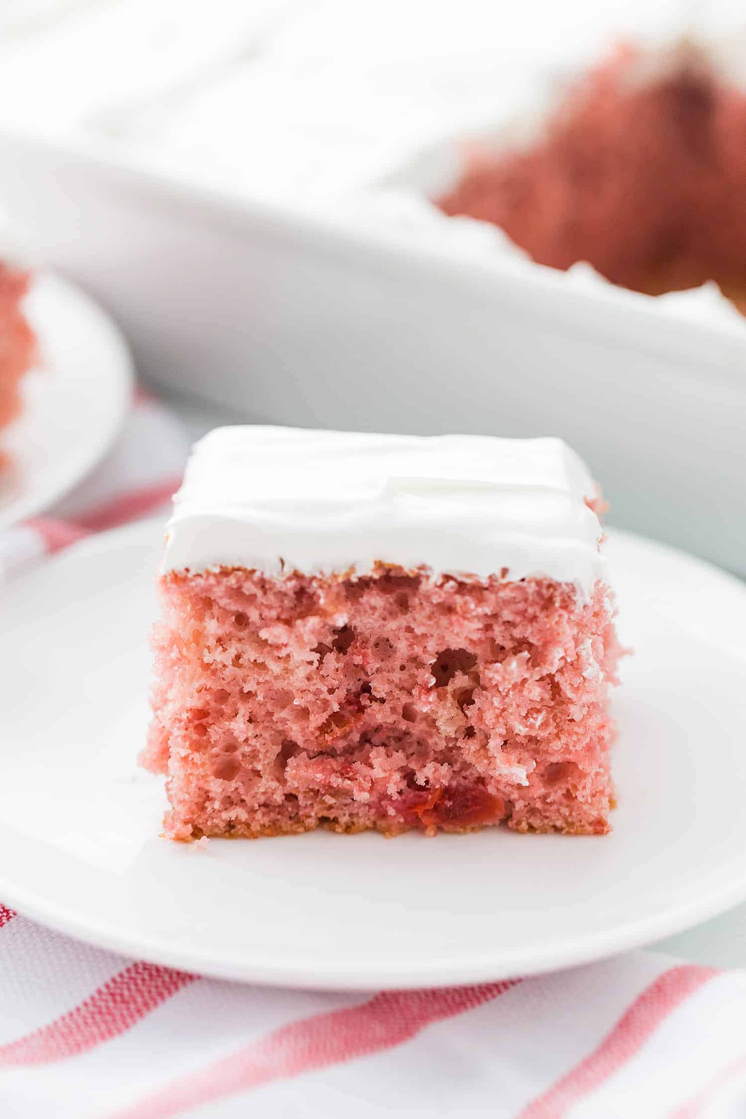 Easy Cherry Cake - Easy cherry cake with whipped topping is unbelievably delicious and requires only a white cake mix, cherry pie filling, and a few other ingredients. Whipped topping frosting is the finishing touch! #cherry #cherrycake #cakemix #cake #baking #sweets #dessert #halfscratched