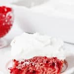 Easy Cherry Cake with Whipped Topping -- This easy cherry cake with whipped topping is unbelievably delicious and requires only a white cake mix, cherry pie filling, and three other ingredients. The whipped topping frosting is a fabulous finishing touch! | halfscratched.com #recipe #cake #valentinesday