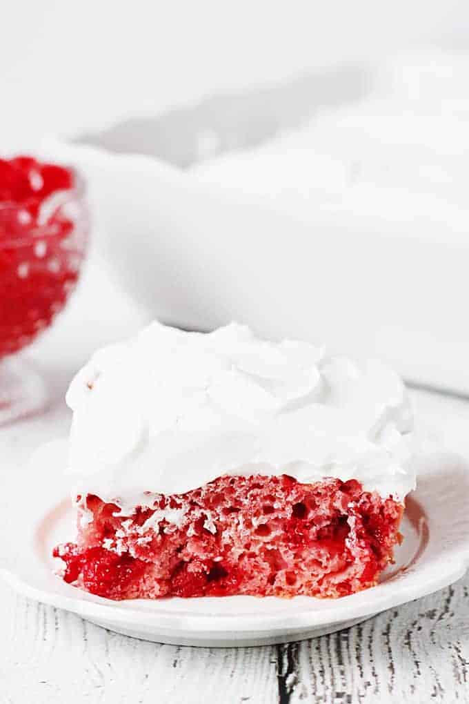 Easy Cherry Cake with Whipped Topping -- This easy cherry cake with whipped topping is unbelievably delicious and requires only a white cake mix, cherry pie filling, and three other ingredients. The whipped topping frosting is a fabulous finishing touch! | halfscratched.com #recipe #cake #valentinesday