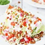Loaded Wedge Salad -- This loaded wedge salad features iceberg lettuce topped with blue cheese dressing, red onion, tomatoes, bacon, blue cheese crumbles, and pecans. It's easier to make than you think! | halfscratched #recipe #salad