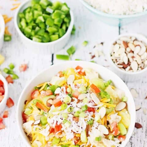 Easy Hawaiian Haystacks -- These easy Hawaiian haystacks area a favorite family meal! A creamy chicken mixture is layered over rice and then topped with a variety of ingredients, from cheese and chopped celery to bell peppers and pineapple. | halfscratched.com
