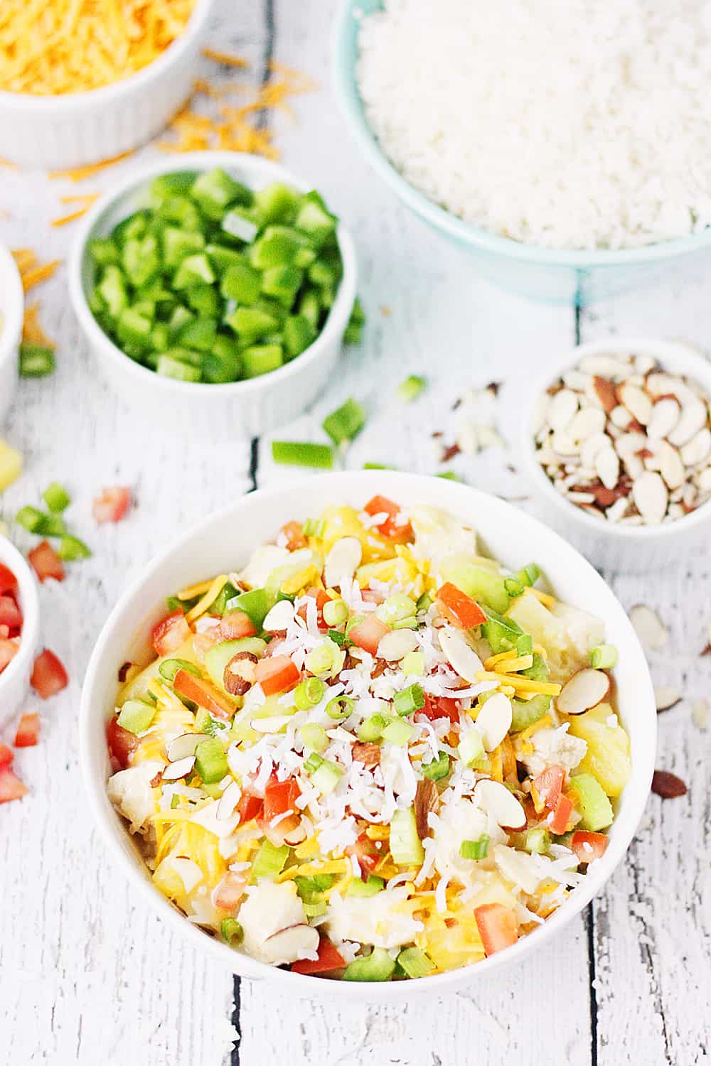 Easy Hawaiian Haystacks -- These easy Hawaiian haystacks area a favorite family meal! A creamy chicken mixture is layered over rice and then topped with a variety of ingredients, from cheese and chopped celery to bell peppers and pineapple. | halfscratched.com