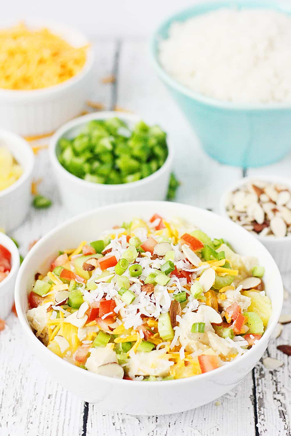 Easy Hawaiian Haystacks -- These easy Hawaiian haystacks area a favorite family meal! A creamy chicken mixture is layered over rice and then topped with a variety of ingredients, from cheese and chopped celery to bell peppers and pineapple. | halfscratched.com