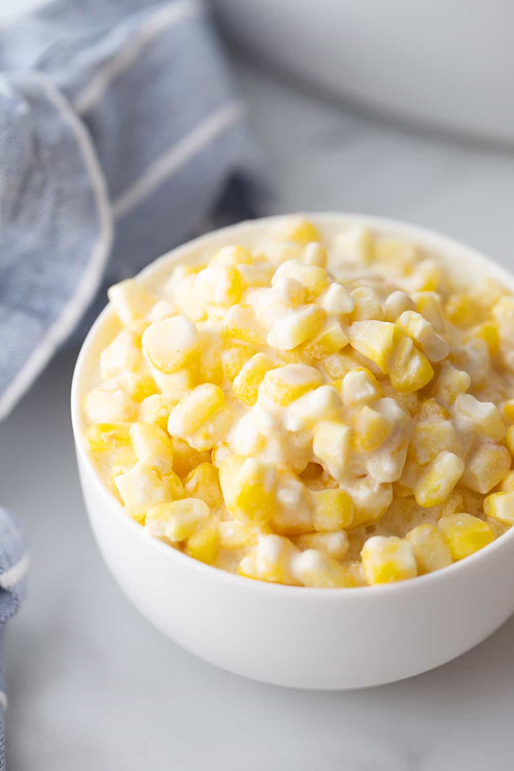 Easy Slow Cooker Creamed Corn - Ready for a side dish that's sure to please everyone? Try this easy, creamy, extra yummy slow cooker creamed corn! #creamedcorn #crockpot #slowcooker #sidedish #easyrecipe #slowcookercreamedcorn #corn #halfscratched