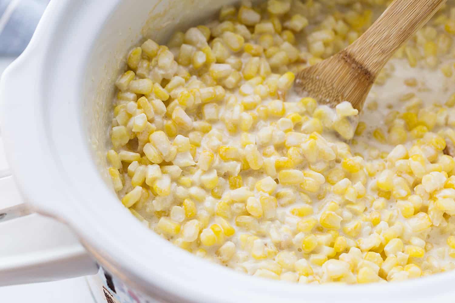 Easy Slow Cooker Creamed Corn - Ready for a side dish that's sure to please everyone? Try this easy, creamy, extra yummy slow cooker creamed corn! #creamedcorn #crockpot #slowcooker #sidedish #easyrecipe #slowcookercreamedcorn #corn #halfscratched