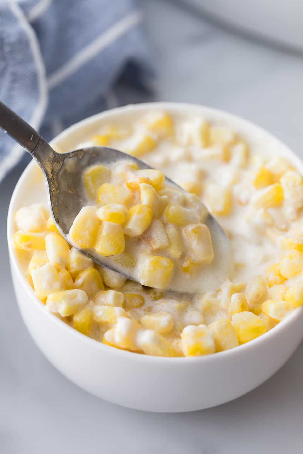 Easy Slow Cooker Creamed Corn - Ready for a side dish that's sure to please everyone? Try this easy, creamy, extra yummy slow cooker creamed corn! #creamedcorn #crockpot #slowcooker #sidedish #easyrecipe #slowcookercreamedcorn #corn #halfscratched