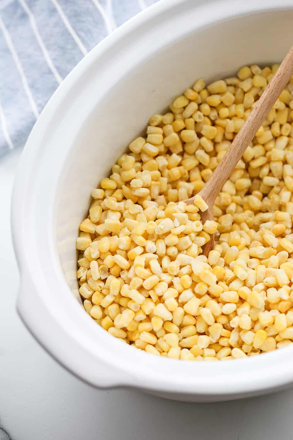 Easy Slow Cooker Creamed Corn - Ready for a side dish that's sure to please everyone? Try this easy, creamy, extra yummy slow cooker creamed corn! #creamedcorn #crockpot #slowcooker #sidedish #easyrecipe #slowcookercreamedcorn #corn #halfscratched