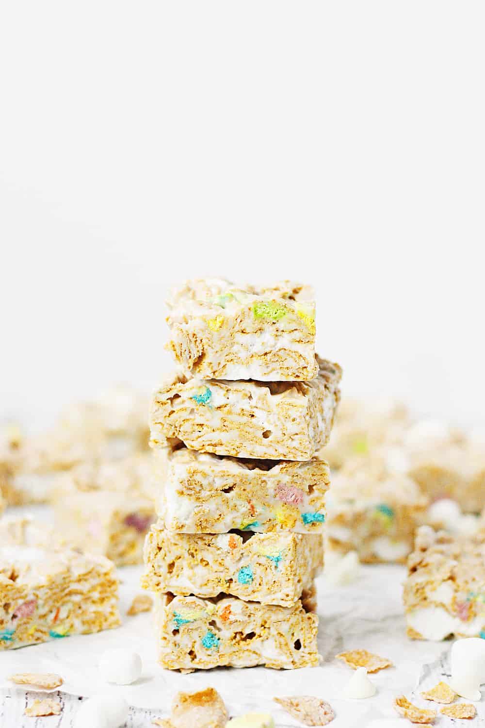 Lucky Charms Frosted Flakes Marshmallow Treats -- You'll think you've died and gone to heaven when you taste these Lucky Charms Frosted Flakes marshmallow treats. They're extra marshmallowy, buttery, and white chocolaty! | halfscratched.com