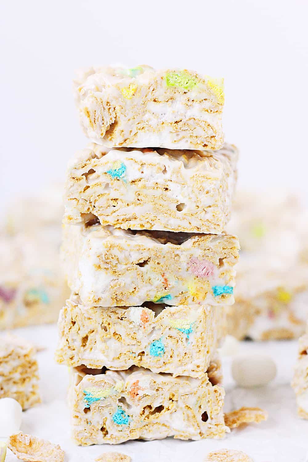 Lucky Charms Frosted Flakes Marshmallow Treats -- You'll think you've died and gone to heaven when you taste these Lucky Charms Frosted Flakes marshmallow treats. They're extra marshmallowy, buttery, and white chocolaty! | halfscratched.com